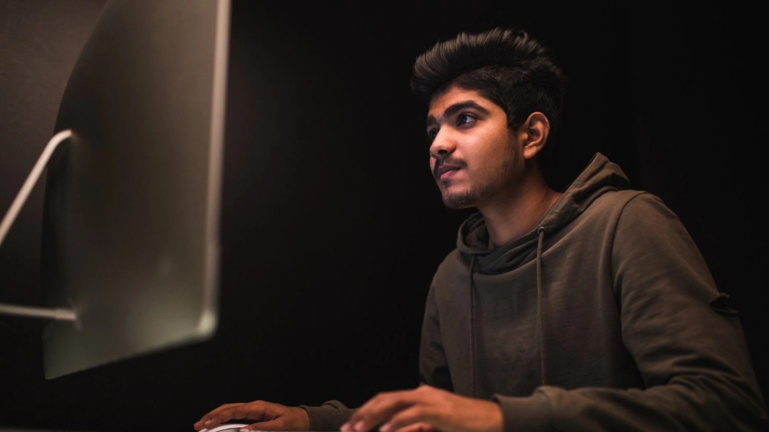 Student coding on a desktop computer during a dot net course.